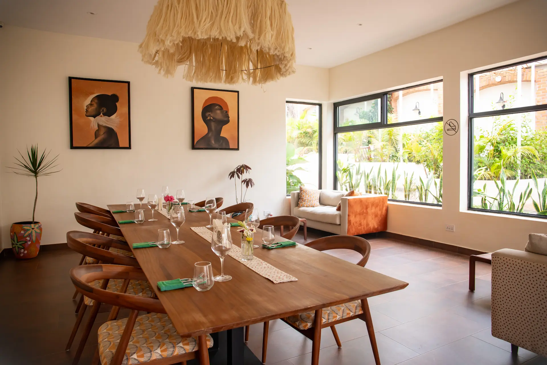 Indoor dining room set for eight with African portrait artworks