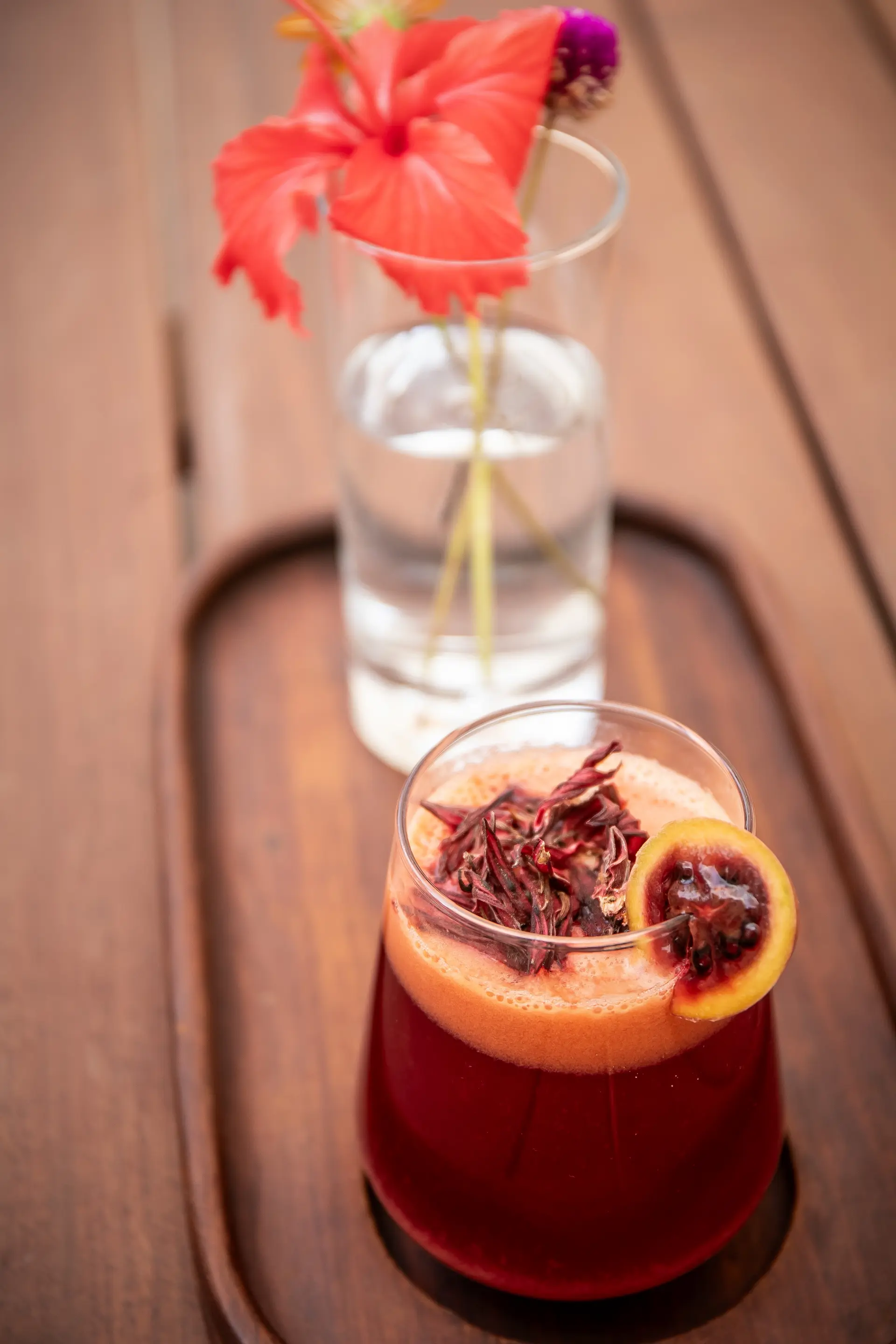 Signature hibiscus cocktail garnished with dried flowers