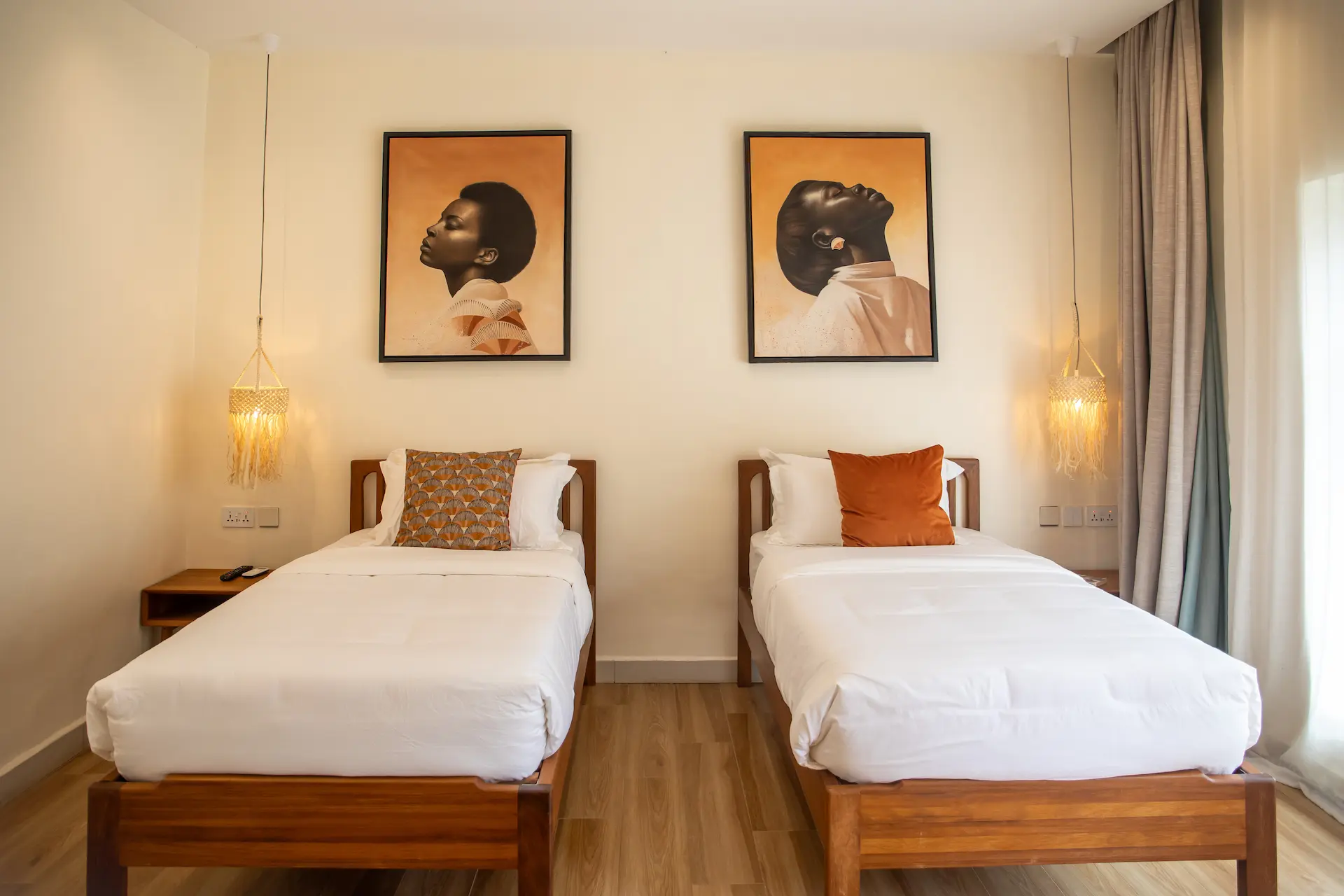 Creative twin room with two single beds and African portrait artworks